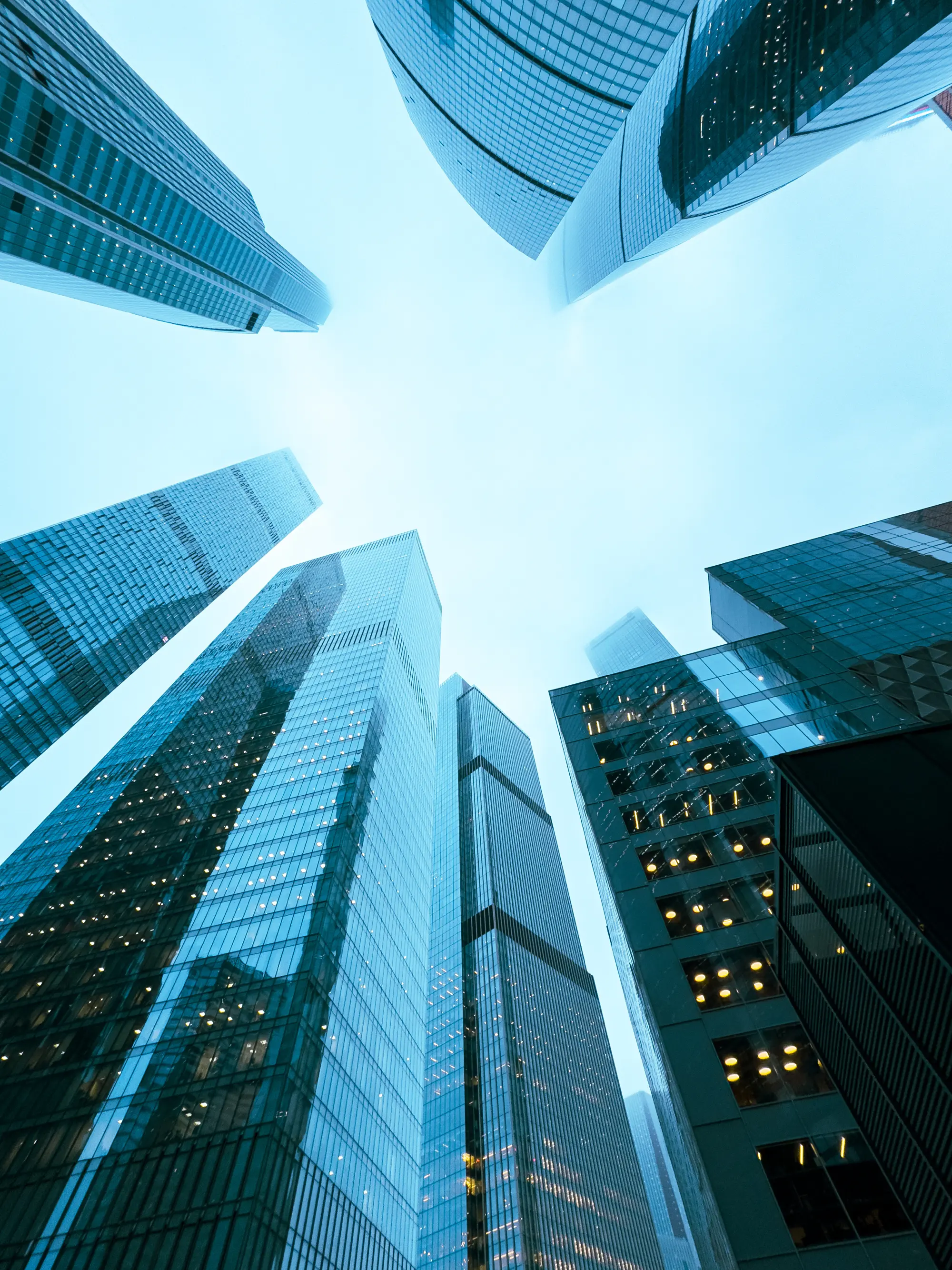 A city skyline with tall buildings and a clear blue sky